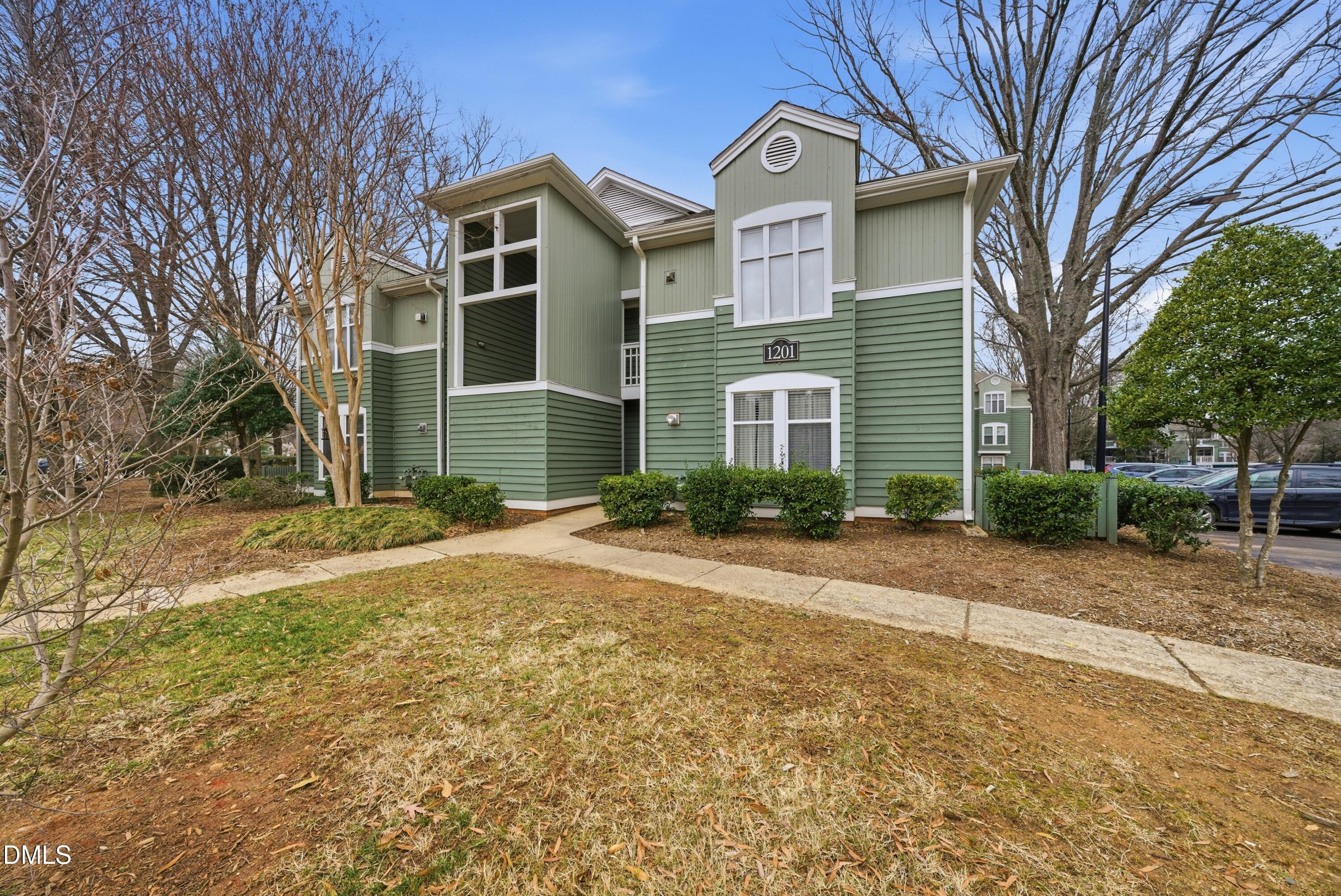 1201 Westview Lane, Unit 105 Raleigh, NC 27605 - Photo 1 of 24 a front view of a house with a yard and garage