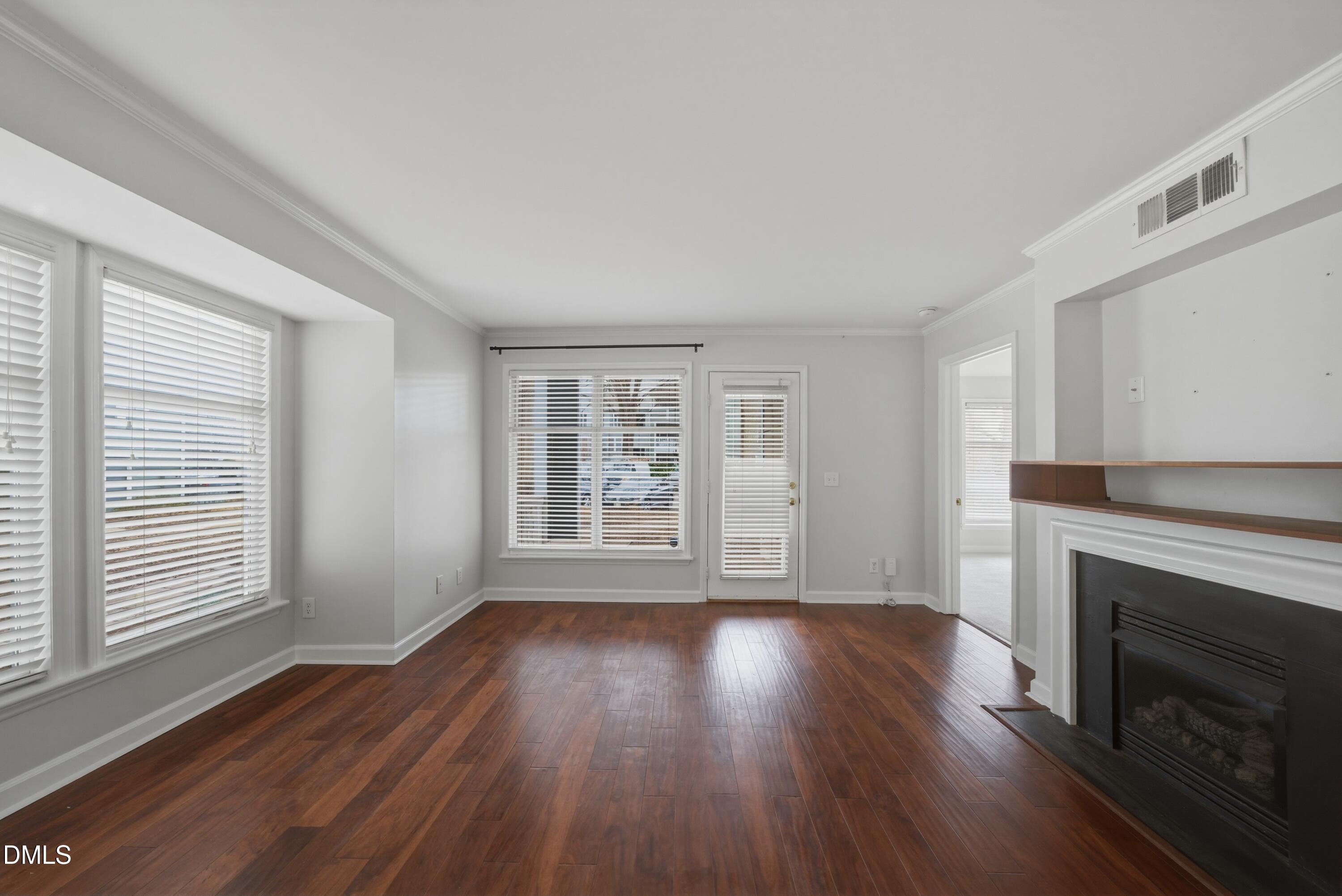 1201 Westview Lane, Unit 105 Raleigh, NC 27605 - Photo 11 of 24 a view of an empty room with wooden floor and a window