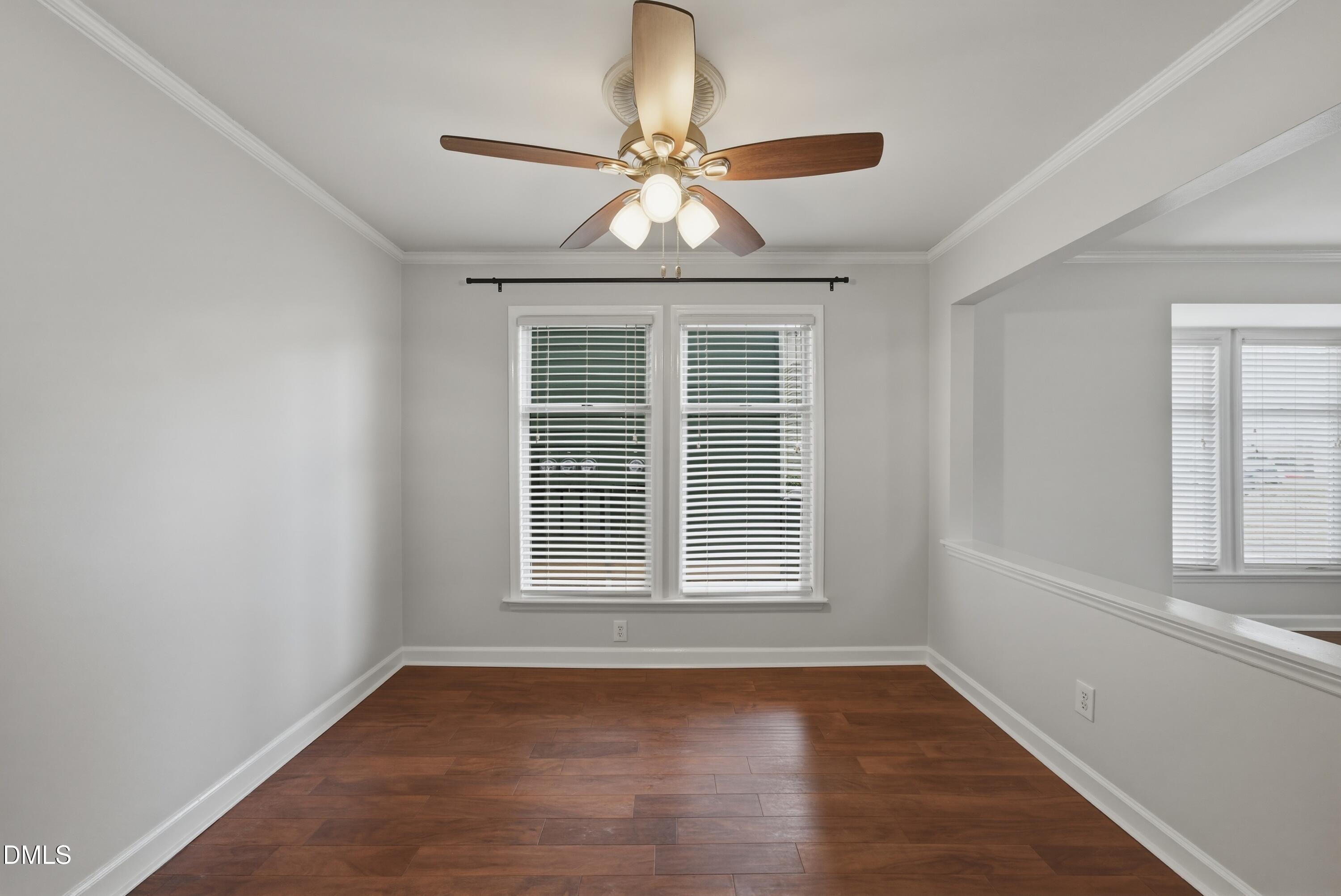 1201 Westview Lane, Unit 105 Raleigh, NC 27605 - Photo 13 of 24 an empty room with wooden floor chandelier and window