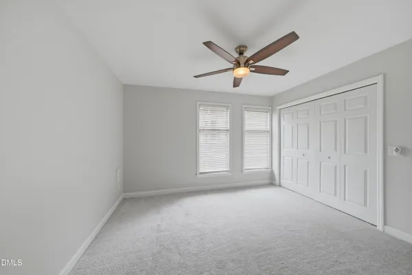 a view of a livingroom with a ceiling fan and window