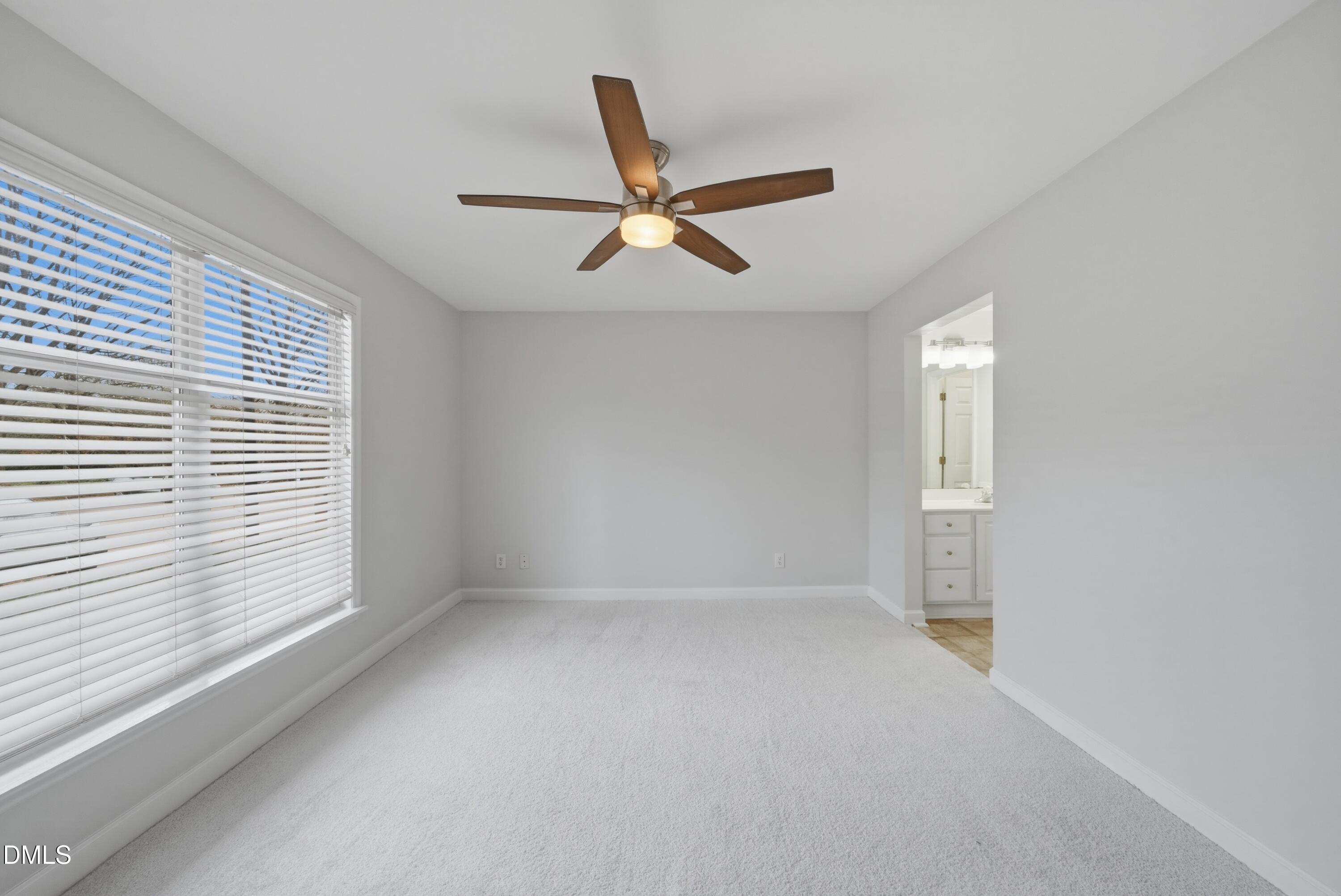 1201 Westview Lane, Unit 105 Raleigh, NC 27605 - Photo 18 of 24 an empty room with a window and a fan