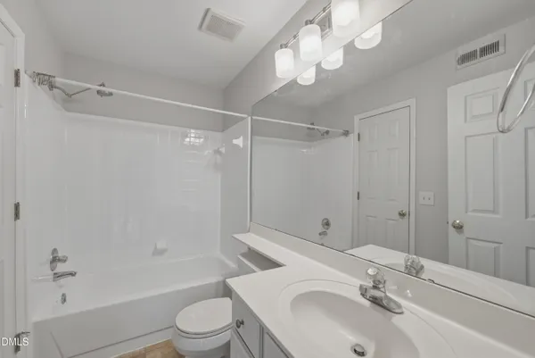 a bathroom with a sink toilet tub and shower