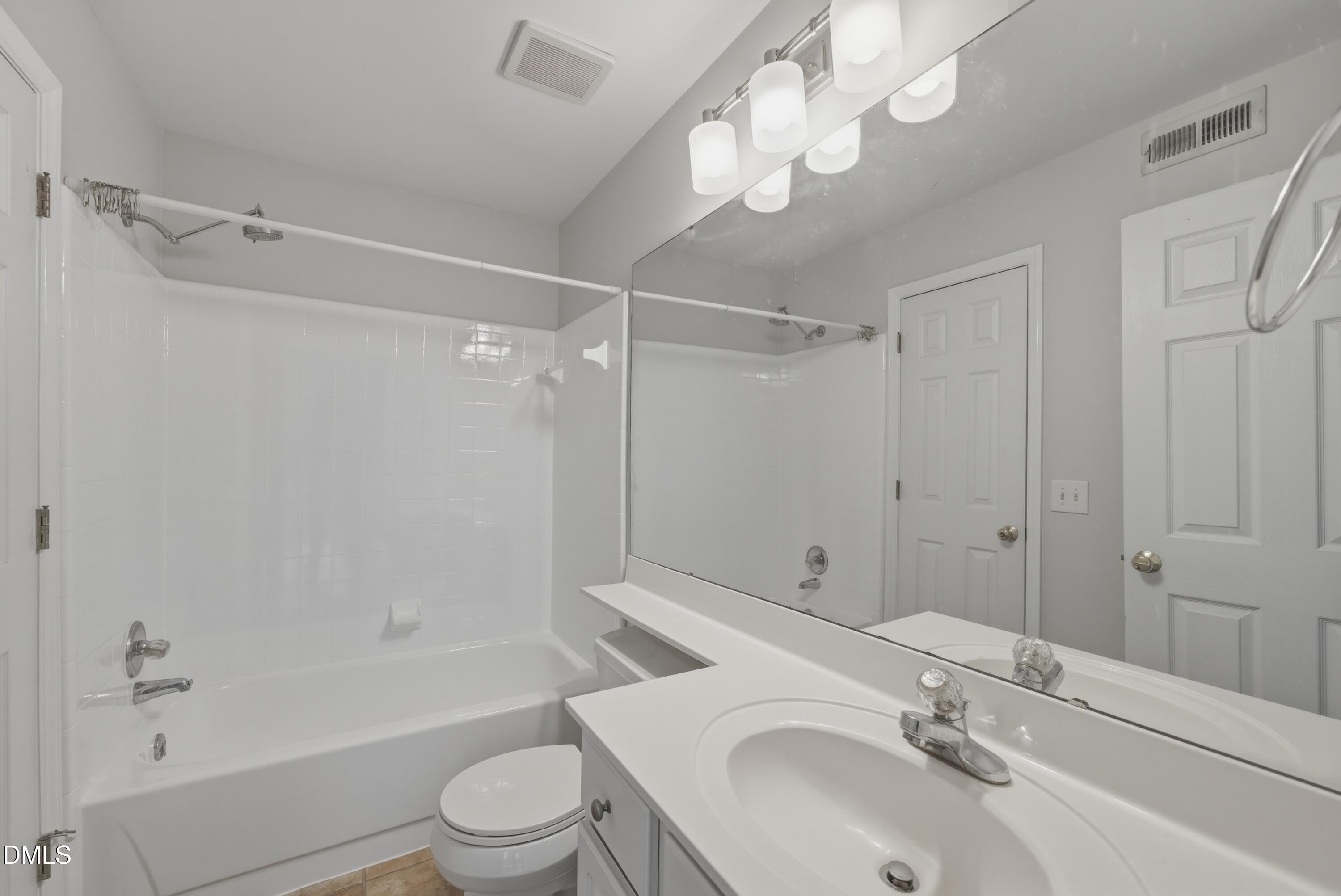 1201 Westview Lane, Unit 105 Raleigh, NC 27605 - Photo 19 of 24 a bathroom with a sink toilet tub and shower