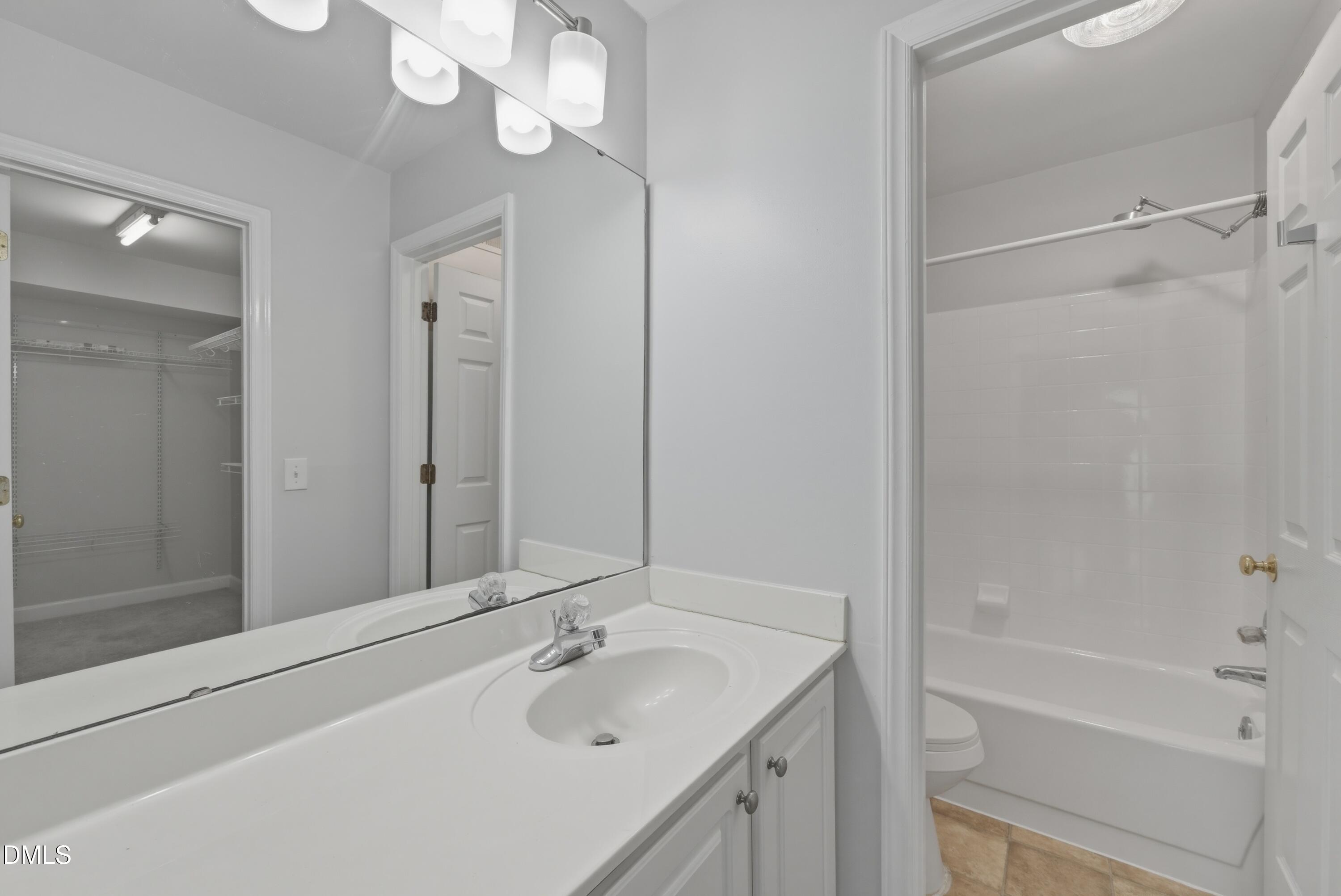 1201 Westview Lane, Unit 105 Raleigh, NC 27605 - Photo 20 of 24 a bathroom with a tub sink vanity granite and mirror