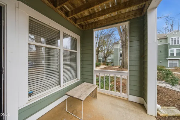 a balcony with furniture and a window