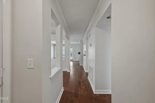 a view of a hallway with wooden floor