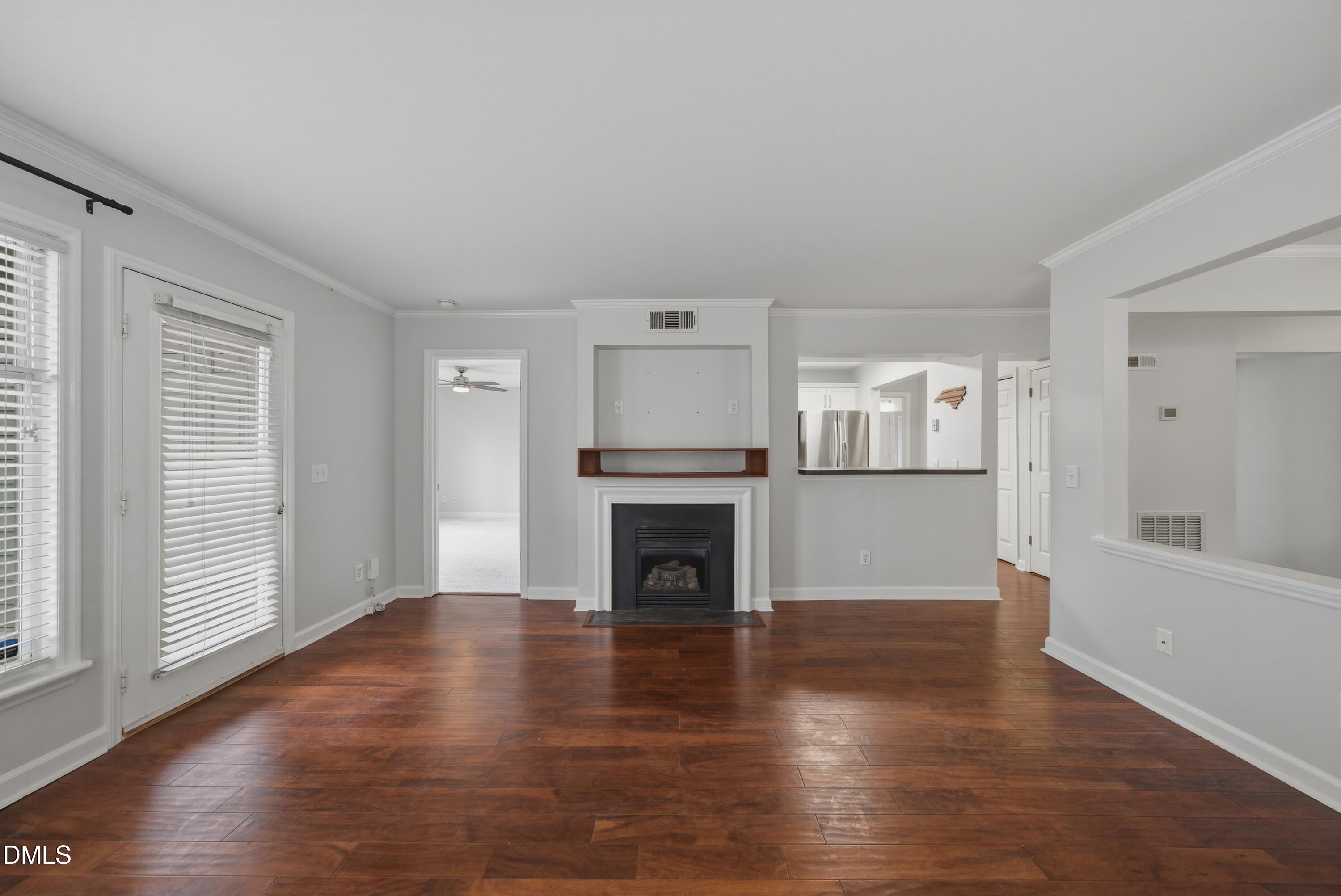 1201 Westview Lane, Unit 105 Raleigh, NC 27605 - Photo 9 of 24 a view of a livingroom with wooden floor and a fireplace