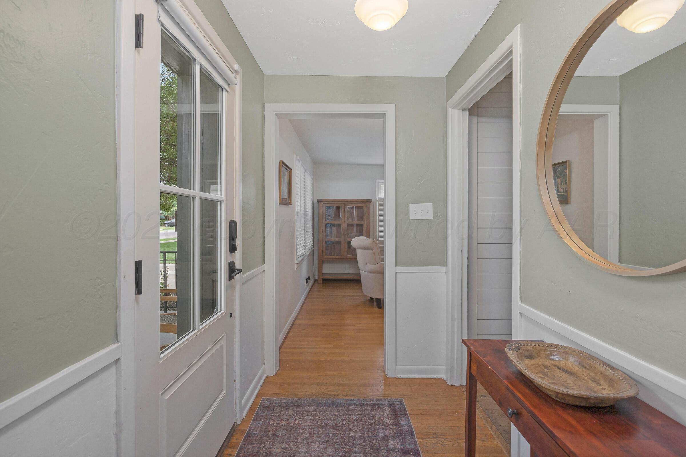 2102 South Hayden Street Amarillo, TX 79109 - Photo 6 of 44 a view of a hallway with wooden floor and staircase