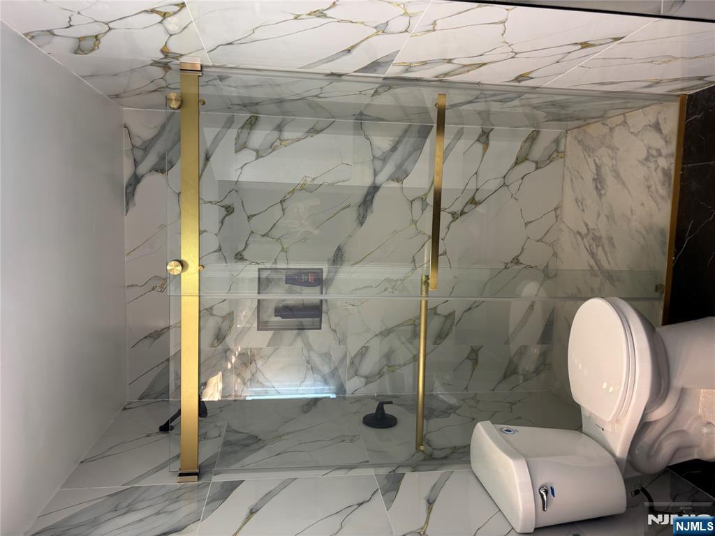 109 Centre Avenue, Unit FIRST Secaucus, NJ 07094 - Photo 13 of 14 a bathroom with a toilet and a shower