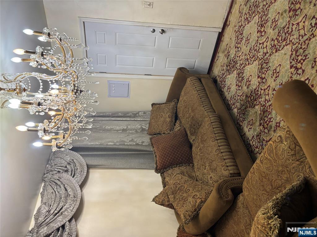 109 Centre Avenue, Unit FIRST Secaucus, NJ 07094 - Photo 4 of 14 a living room with furniture and a chandelier