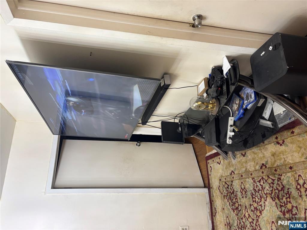 109 Centre Avenue, Unit FIRST Secaucus, NJ 07094 - Photo 6 of 14 a room with wooden floor and furniture