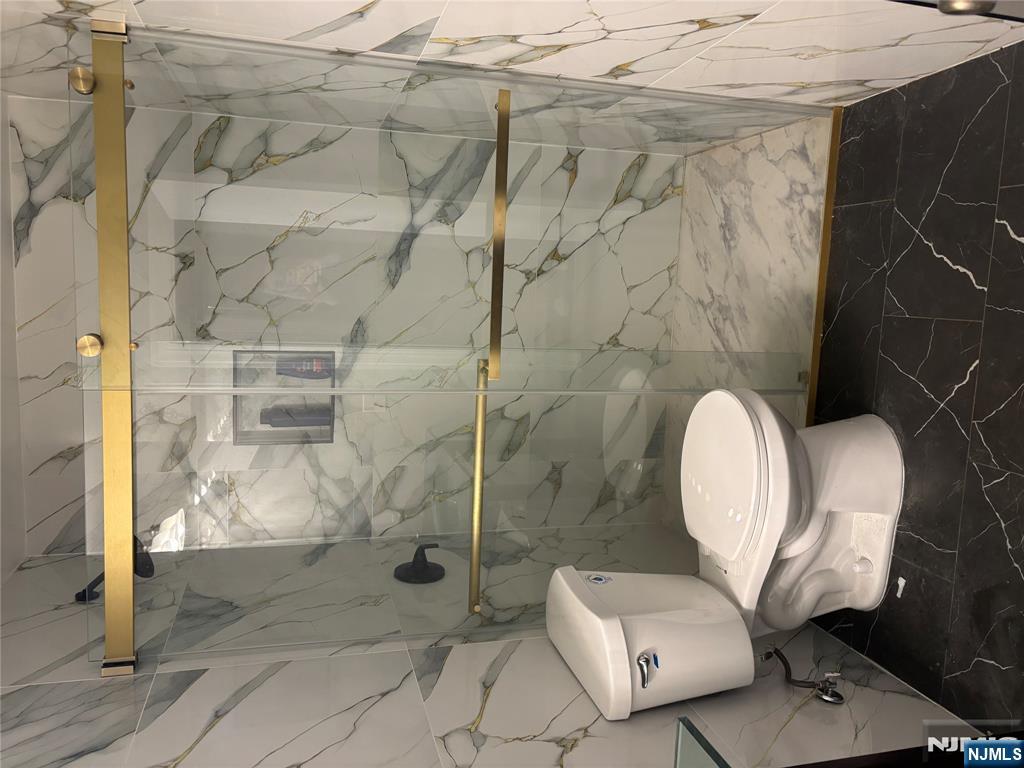 109 Centre Avenue, Unit FIRST Secaucus, NJ 07094 - Photo 10 of 14 a bathroom with a toilet and a shower