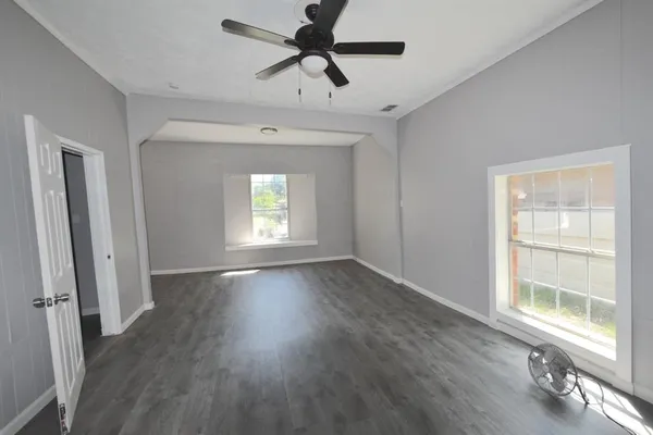 wooden floor in an empty room with a window