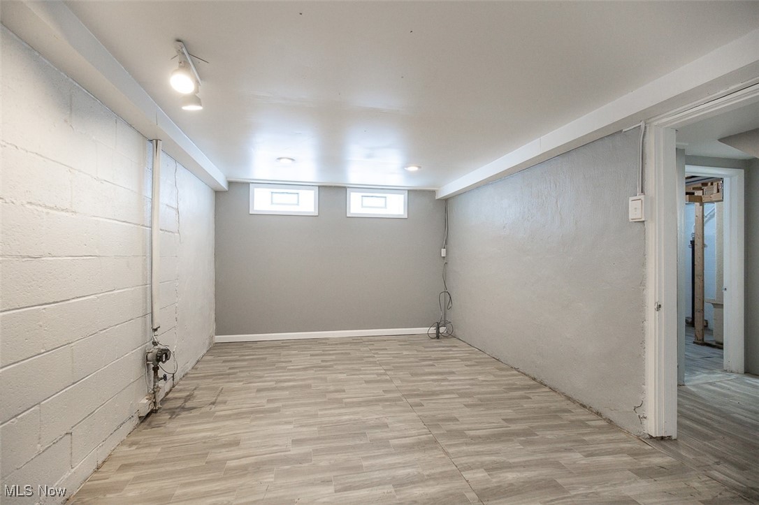 12328 Granger Road Cleveland, OH 44125 - Photo 35 of 37 Below grade area with concrete block wall and light wood finished floors