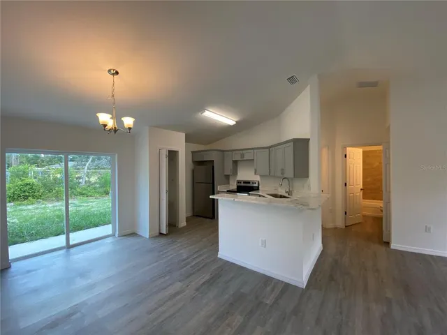 a kitchen with a sink and a stove top oven