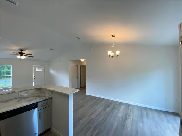 a view of a kitchen with a sink and a wooden floor