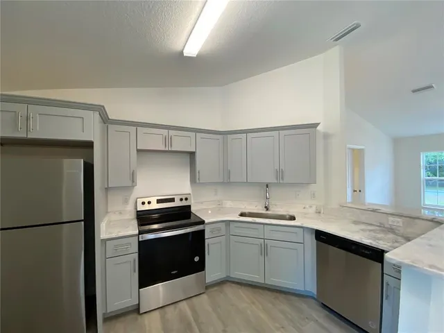 a kitchen with a refrigerator and a sink