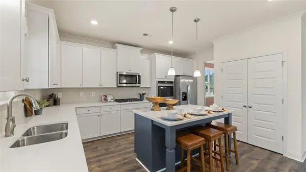 a kitchen with a sink stove and cabinets