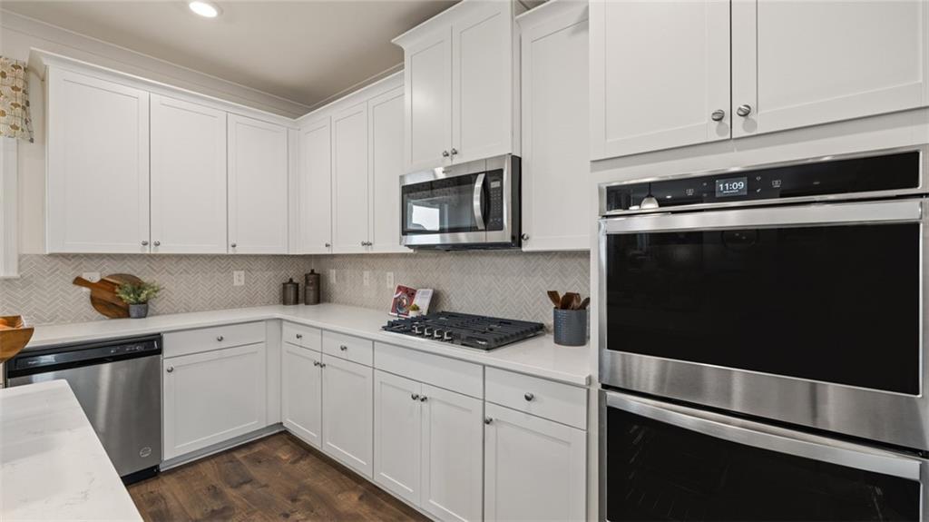 1784 Goodwin Drive Hampton, GA 30228 - Photo 17 of 56 a kitchen with granite countertop white cabinets and black appliances