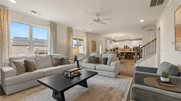 a living room with furniture a rug and a window