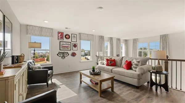 a living room with furniture and paintings on the wall