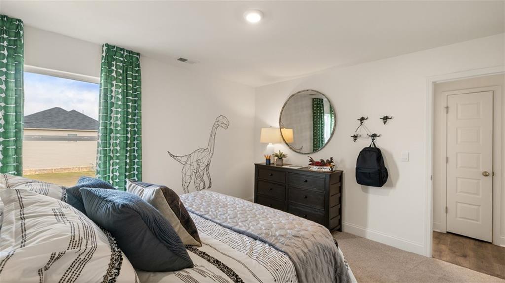 1784 Goodwin Drive Hampton, GA 30228 - Photo 45 of 56 a bedroom with a bed and a chandelier