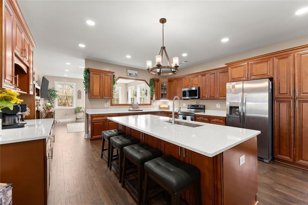 152 Grover Taylor Road Demorest, GA 30535 - Photo 12 of 68 a kitchen with stainless steel appliances granite countertop a refrigerator a sink dishwasher a stove and a dining table with wooden floor