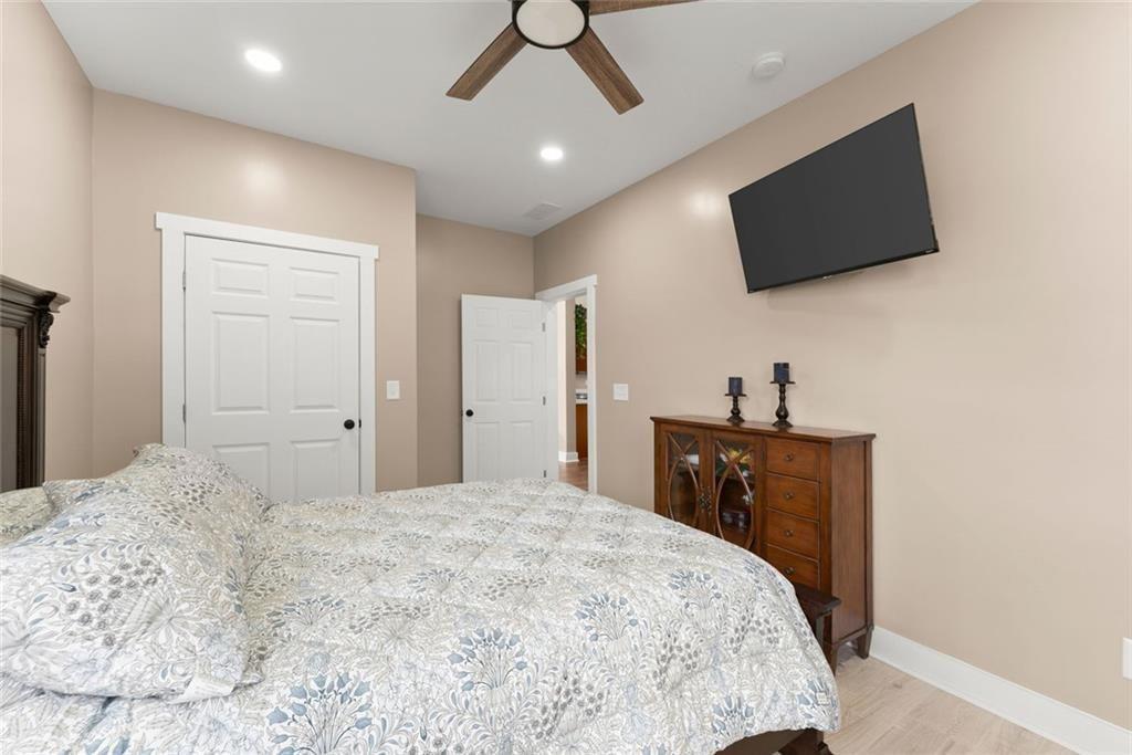 152 Grover Taylor Road Demorest, GA 30535 - Photo 21 of 68 a bedroom with a bed and a flat screen tv