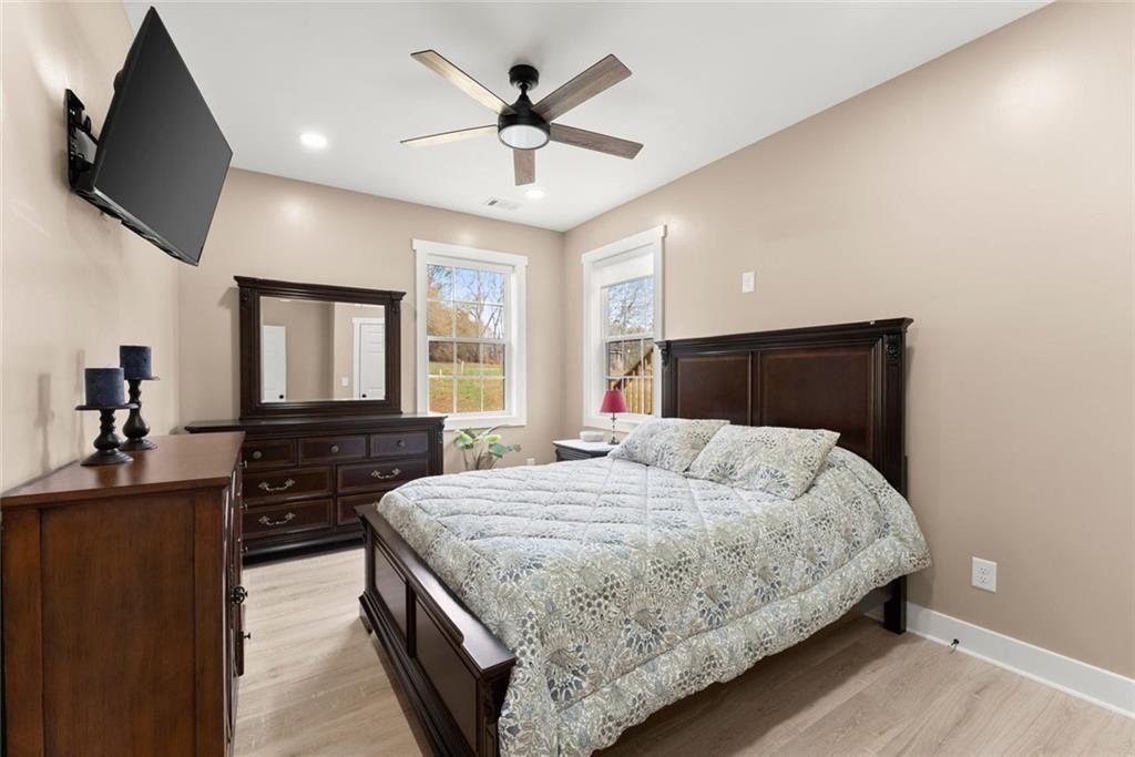 152 Grover Taylor Road Demorest, GA 30535 - Photo 22 of 68 a bedroom with a bed and a flat screen tv