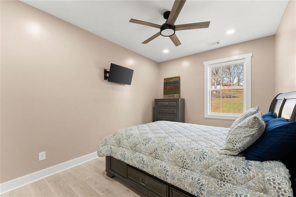 152 Grover Taylor Road Demorest, GA 30535 - Photo 22 of 68 a bedroom with a large bed and a window