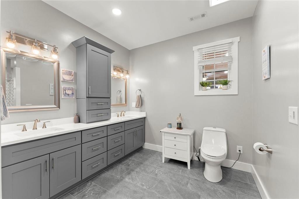 152 Grover Taylor Road Demorest, GA 30535 - Photo 29 of 68 a bathroom with a toilet sink and mirror