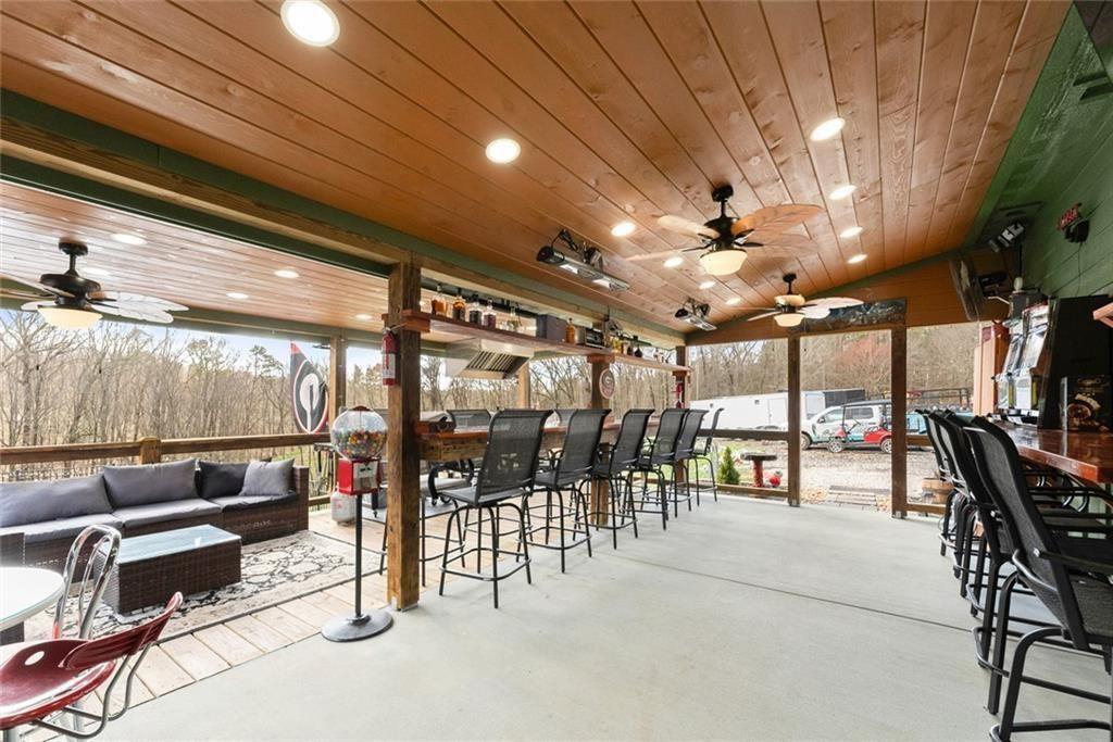 152 Grover Taylor Road Demorest, GA 30535 - Photo 49 of 68 a outdoor space with lots of tables a chandelier and couches