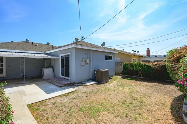 a view of a house with a small yard and wooden fence