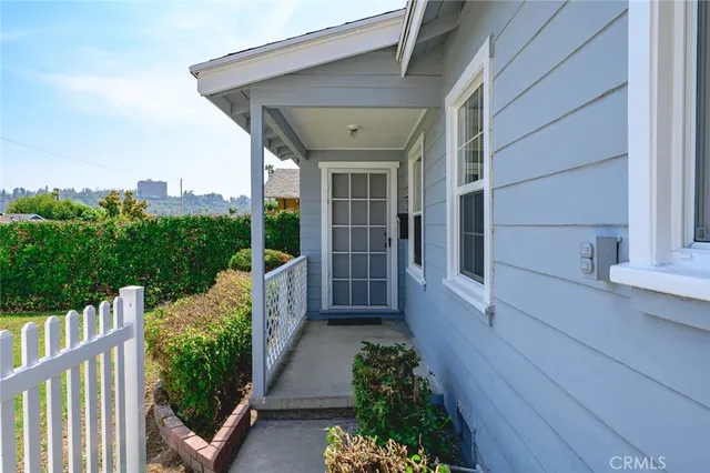 a view of a pathway of a house with wooden floor and fence
