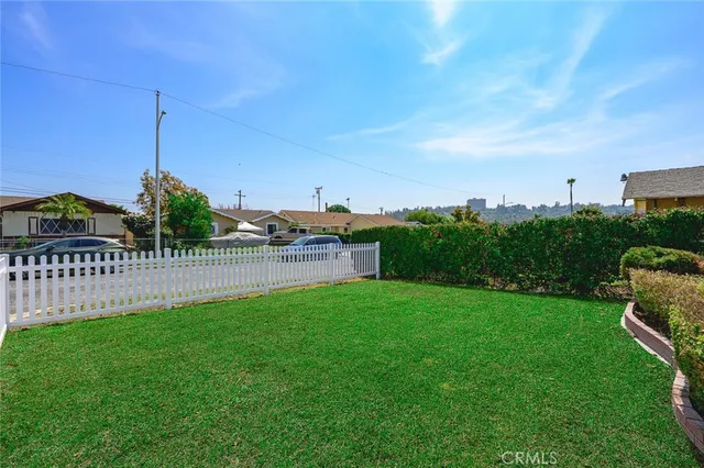 a view of a garden with a building in the background