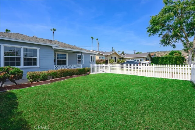 a view of a house with a yard and a porch