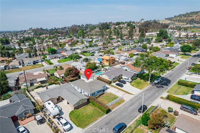 an aerial view of multiple houses with a yard