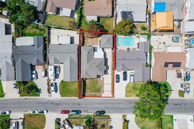 an aerial view of residential houses with outdoor space