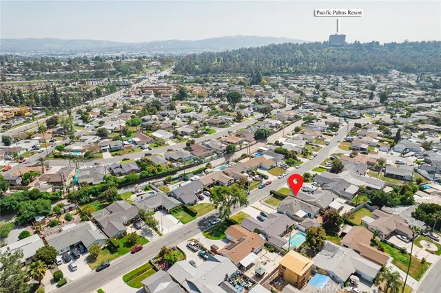 an aerial view of house with yard and parking space