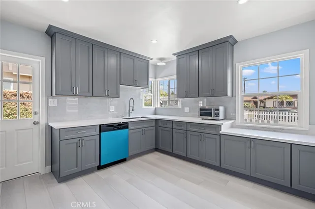 a kitchen with sink cabinets and window