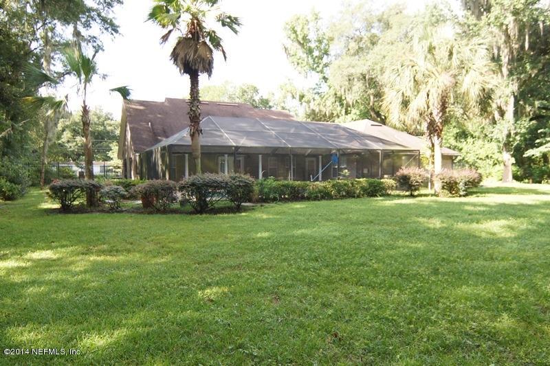 4743 Herton Road Jacksonville, FL 32258 - Photo 5 of 34 Exterior Back of Home & Pool Enclosure