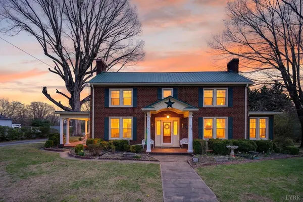 a front view of a brick house with a yard