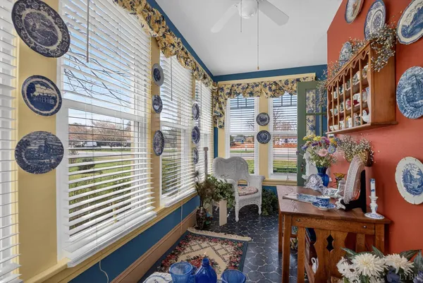 a living room with wooden floor and a rug