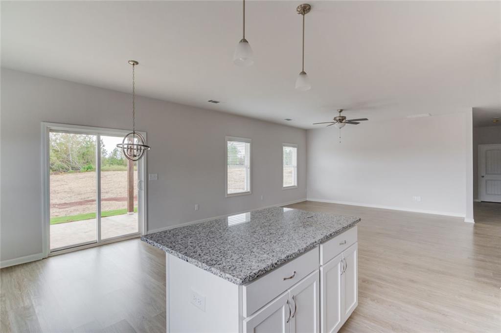 255 Cool Springs Road, Unit 7 Clarkesville, GA 30523 - Photo 16 of 42 a kitchen with kitchen island a counter top space and a sink