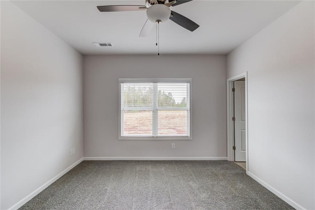 255 Cool Springs Road, Unit 7 Clarkesville, GA 30523 - Photo 21 of 42 an empty room with a window and a fan