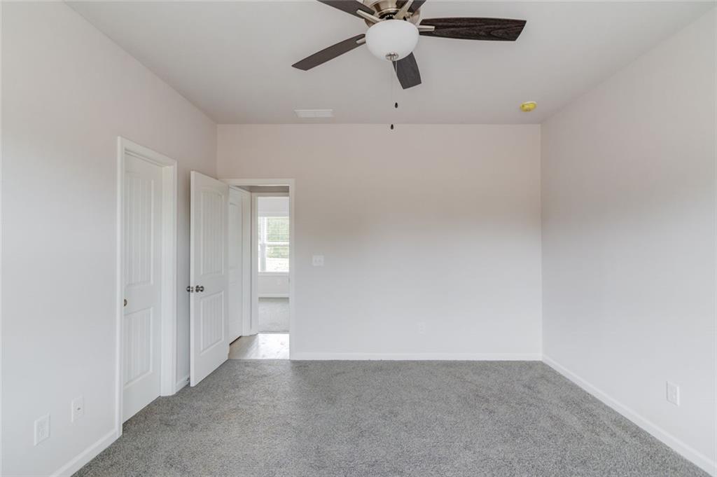 255 Cool Springs Road, Unit 7 Clarkesville, GA 30523 - Photo 22 of 42 an empty room with a ceiling fan and a window