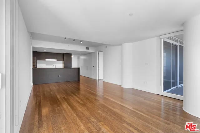 a view of an empty room and wooden floor