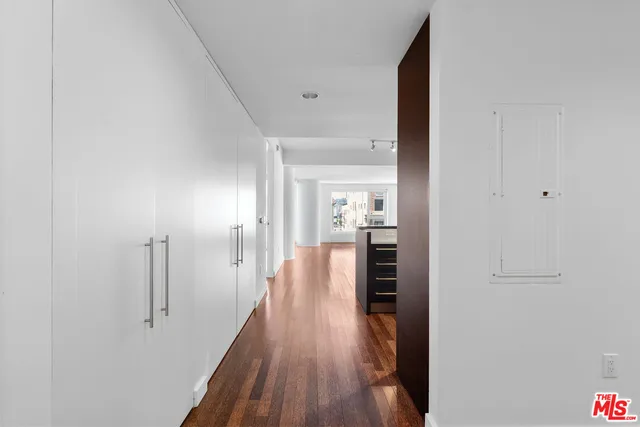 a view of hallway with wooden floor