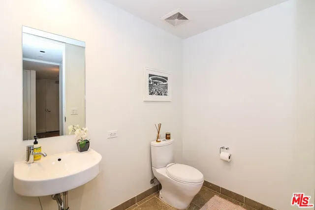 a bathroom with a sink a mirror and a toilet