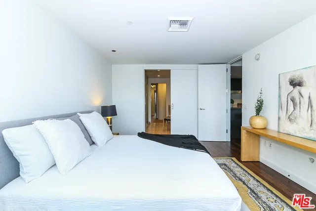 a bedroom with a bed and a lamp